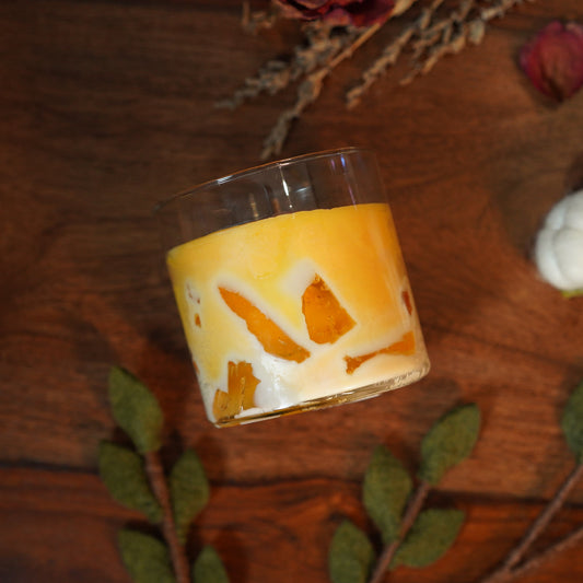Realistic mango shake candle in glass jar with whipped wax topping
